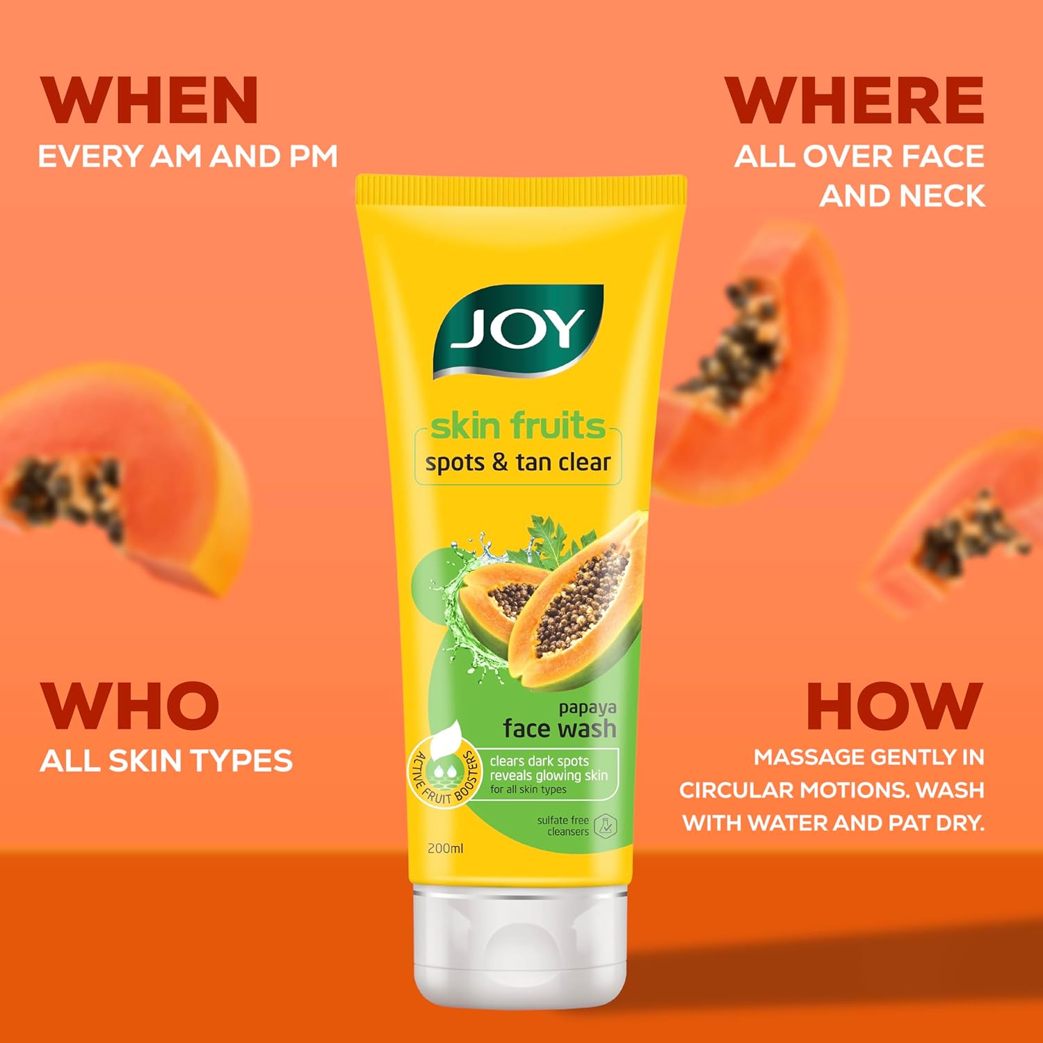 Joy skin fruits face wash tube with papaya slices on an orange background