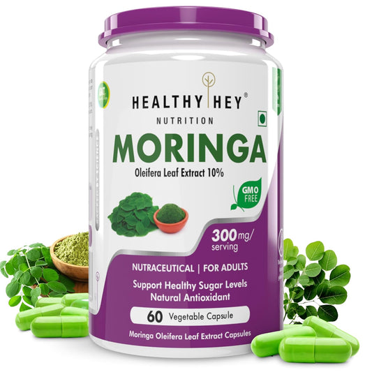 Moringa supplement container with green leaves and capsules on a white background