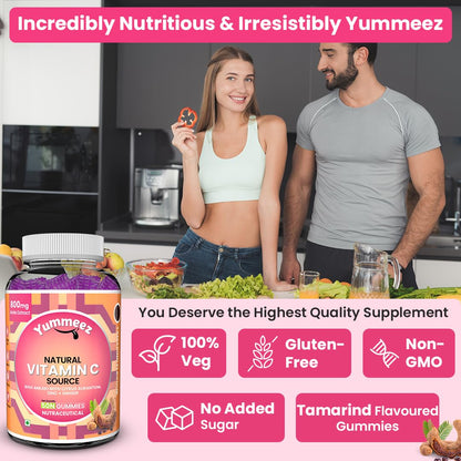 Two people in a kitchen with a Yummee's vitamin supplement bottle and food.