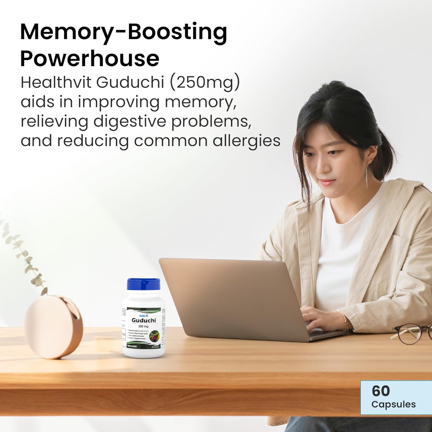 Woman working on a laptop with Healthvit Guduchi supplement on a table