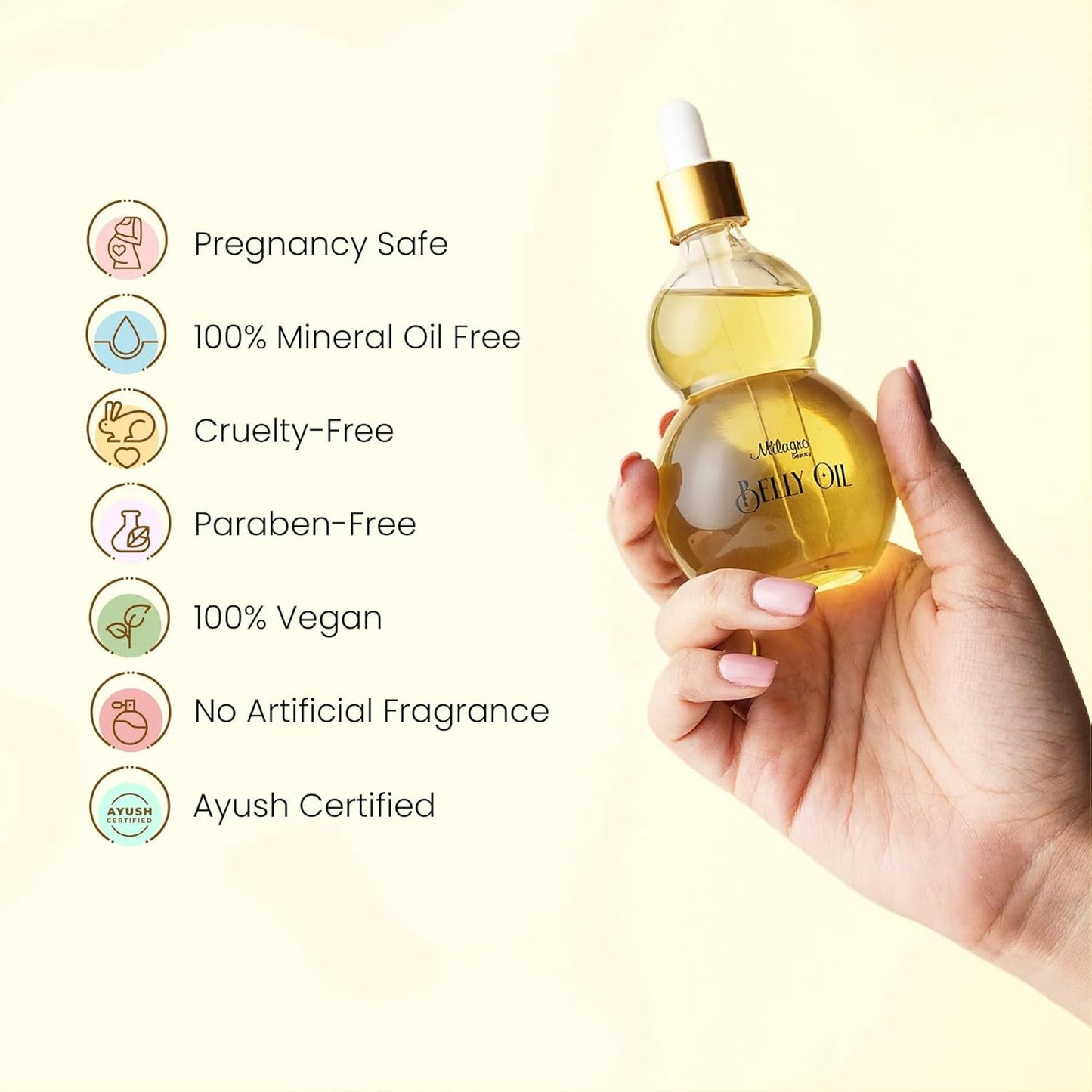 Hand holding a bottle of oil with certification icons on a light yellow background