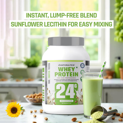 Whey protein container with a green smoothie and sunflower on a kitchen counter