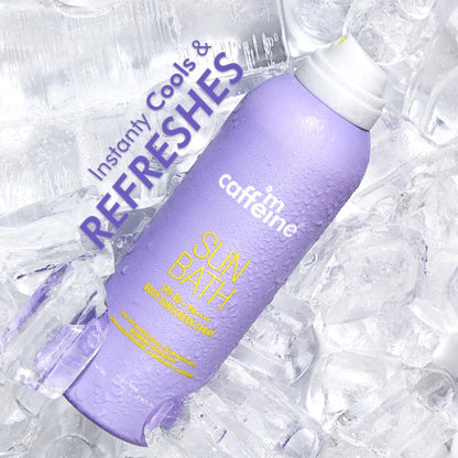 Purple bottle labeled 'Sun Bath' with text 'Instantly Cools & Refreshes' on a textured white background.