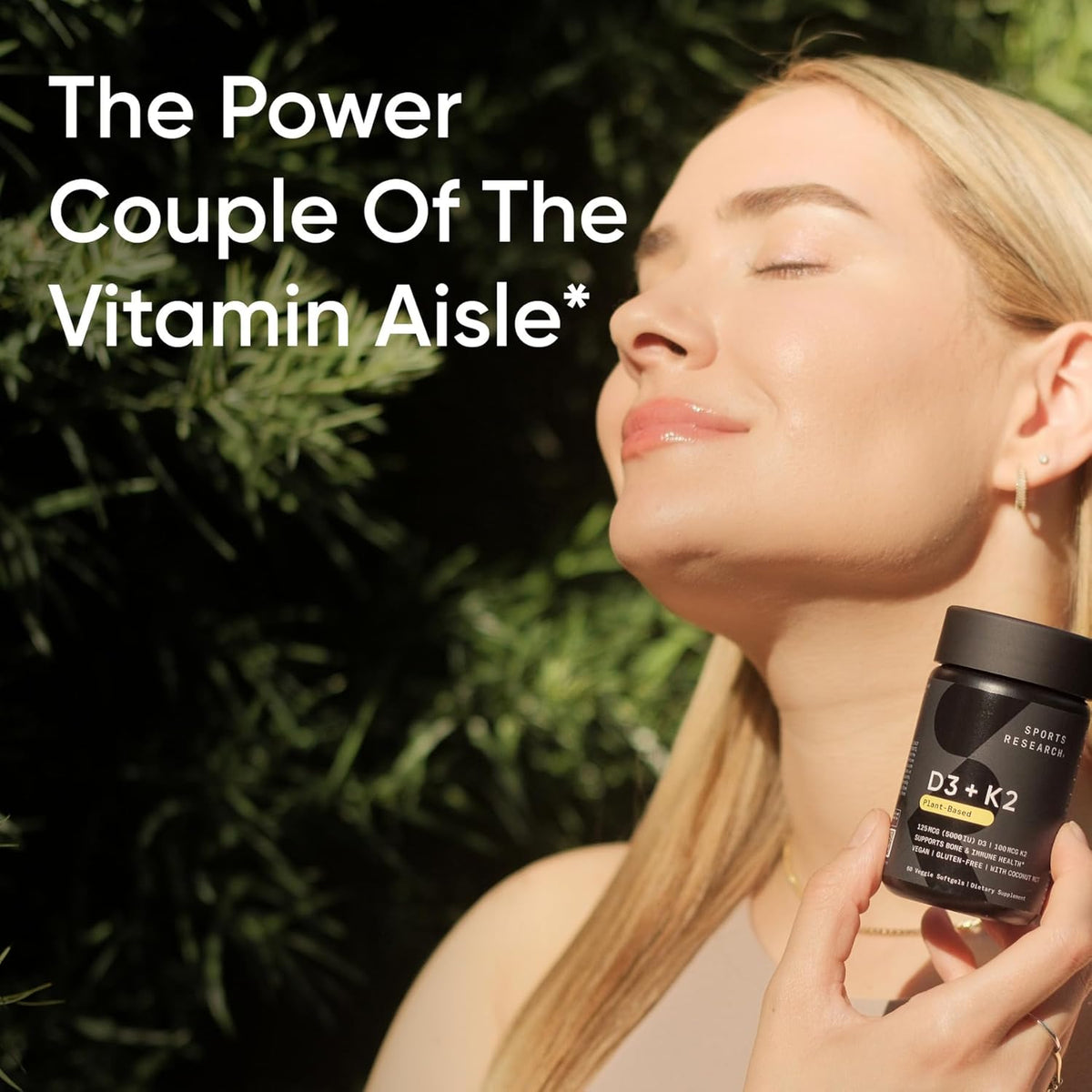 Woman holding a supplement bottle with text about vitamins