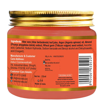 Back view of a cosmetic jar with gold lid and red label displaying ingredients and branding.