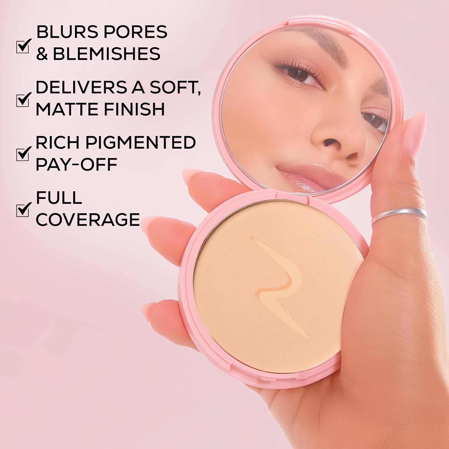 Hand holding a pink compact mirror with a powder compact, showcasing product features on a pink background.