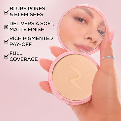 Hand holding a pink compact mirror with a powder compact, showcasing product features on a pink background.