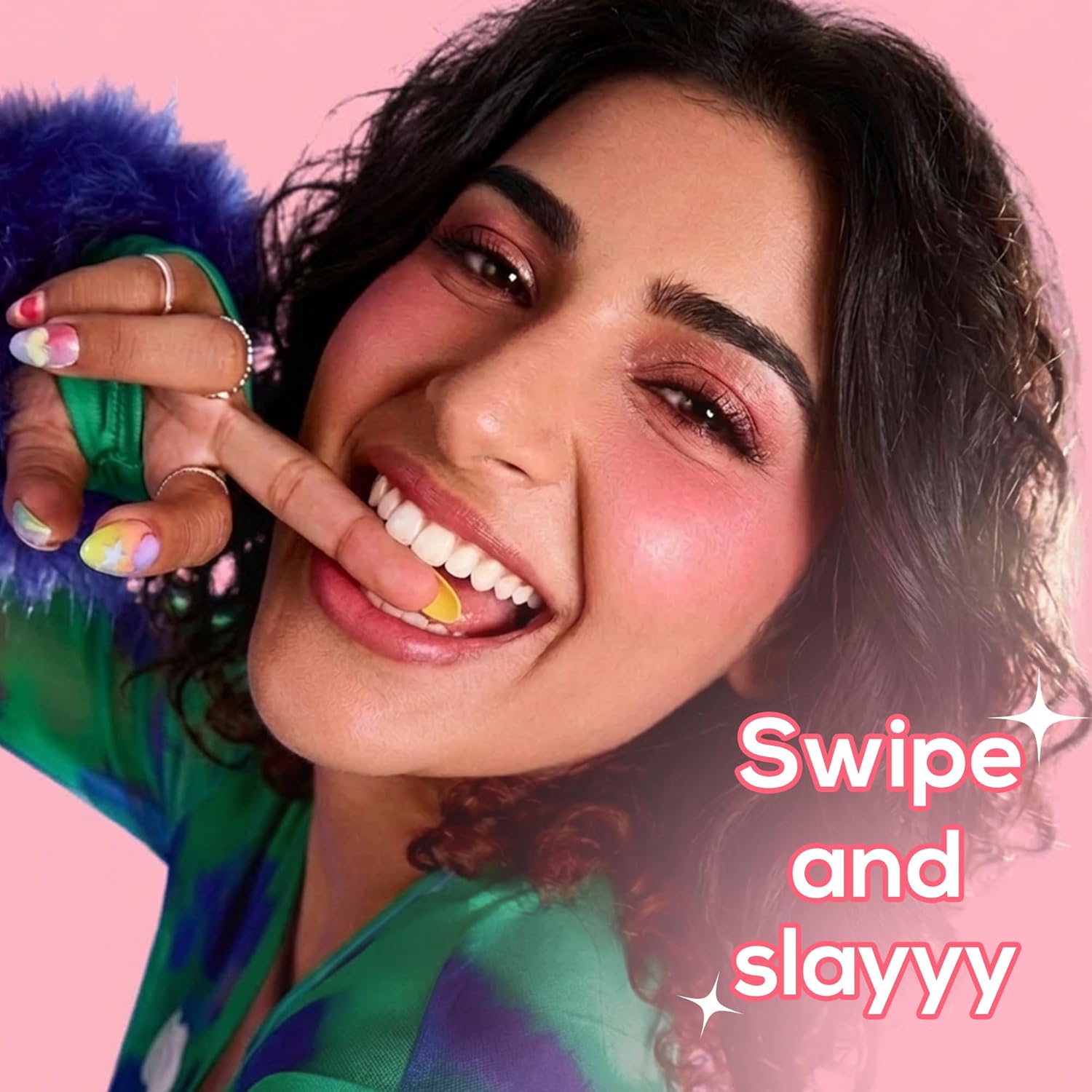 Woman with colorful nails and makeup against a pink background with 'Swipe and slayyy' text.