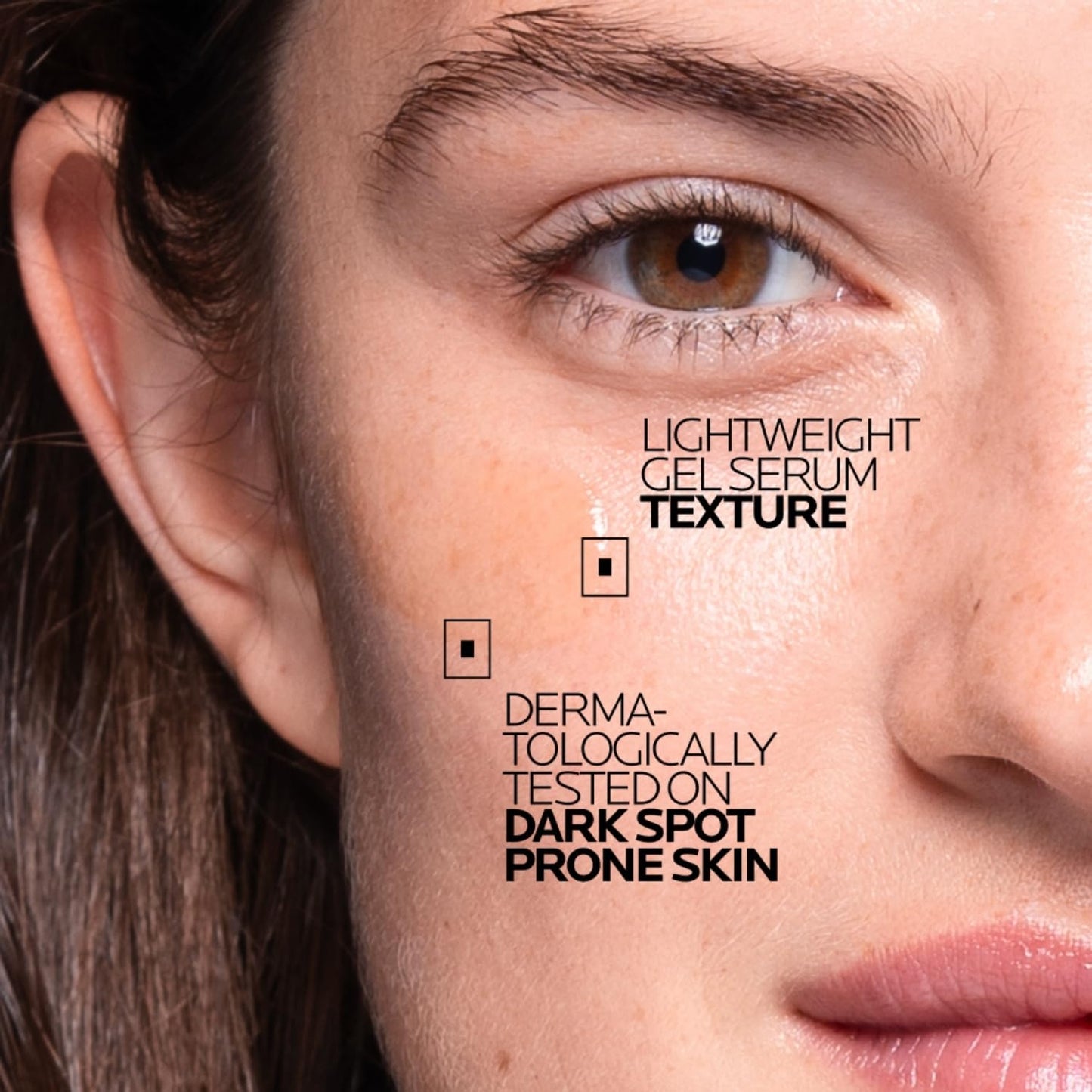 Close-up of a person's face with text about a skincare product on the skin.
