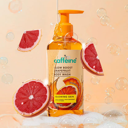 Caffeine body wash bottle with grapefruit slices and bubbles on a peach background