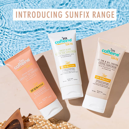 Three sunscreen products from the Sunfix range by mCaffeine on a sandy background with water in the background.