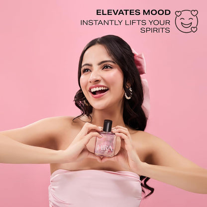 Woman holding a perfume bottle with text on a pink background