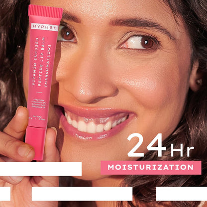 Woman holding a pink lip balm with 'Hyphen' branding, emphasizing 24-hour moisturization.