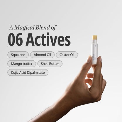 Hand holding a skincare stick with ingredients listed on a light gray background