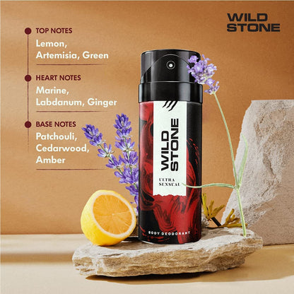 Wild Stone deodorant spray with botanical elements on a stone surface against a brown background