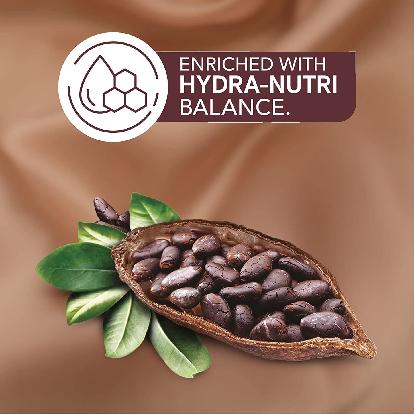 Cocoa bean pod with green leaves and 'Enriched with Hydra-Nutri Balance' label on a brown background