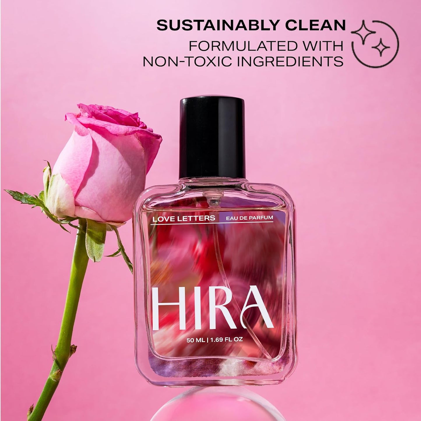 HIRA perfume bottle with a pink rose on a pink background, labeled as sustainably clean.