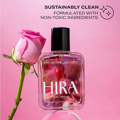 HIRA perfume bottle with a pink rose on a pink background, labeled as sustainably clean.