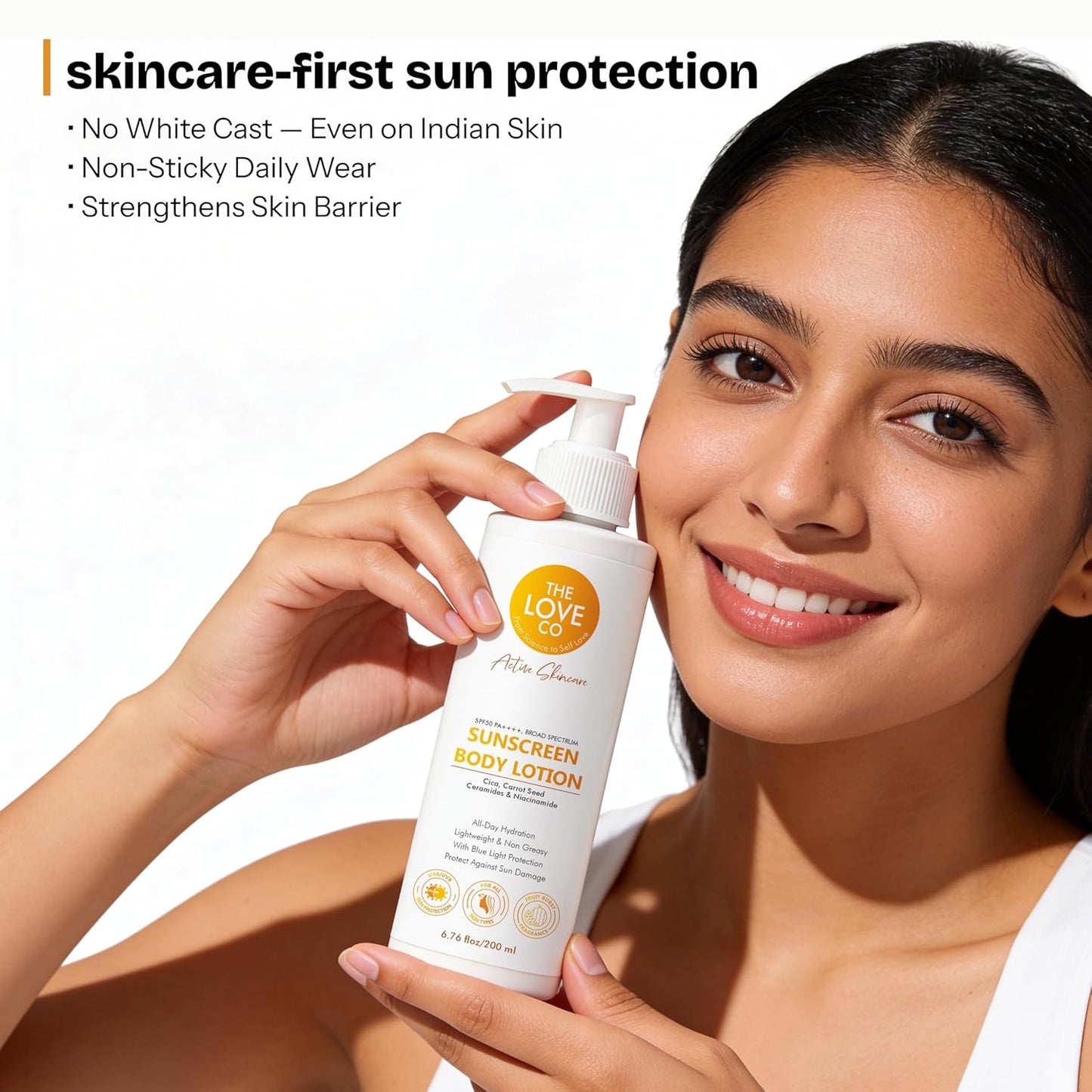 Woman holding a bottle of sunscreen lotion with product details on a white background