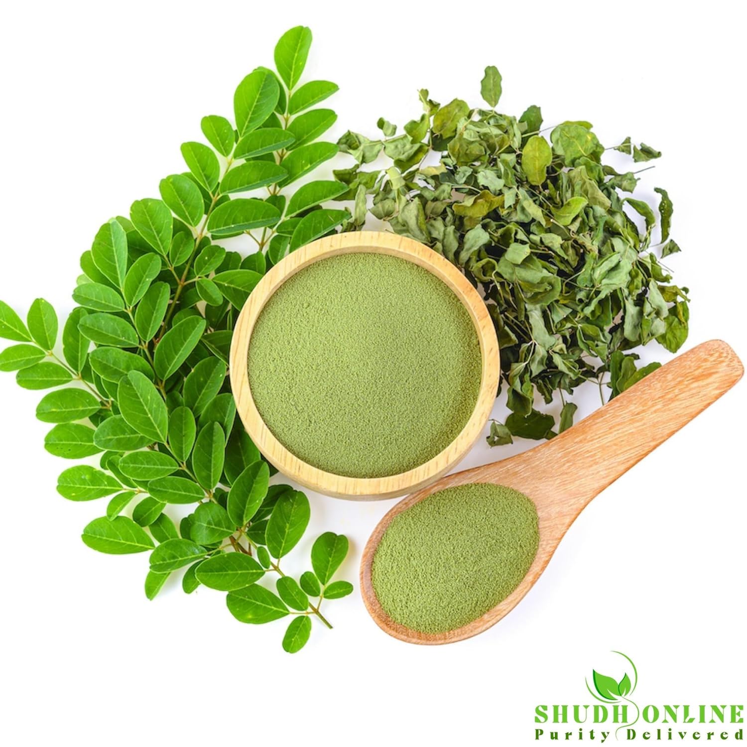 Green powder in a wooden bowl and spoon with fresh green leaves on a white background, Shudh Online brand visible.