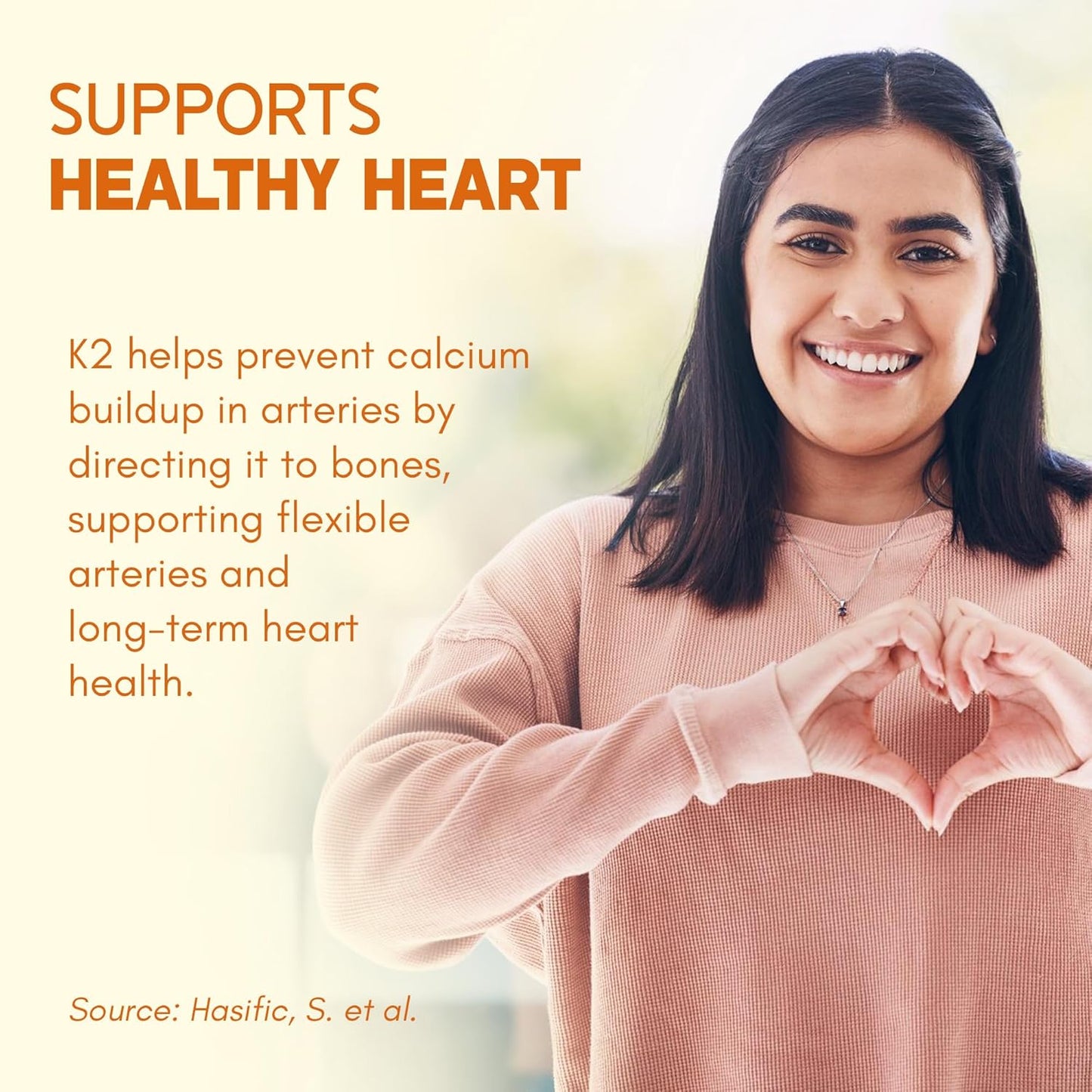 Woman making a heart shape with her hands with text about K2 supporting healthy heart health.