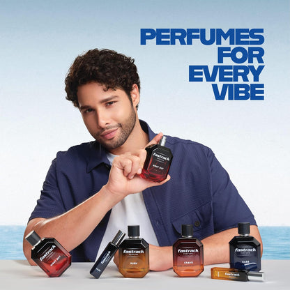 Man holding a Fastrack perfume bottle with other bottles displayed in front, against a light blue background.