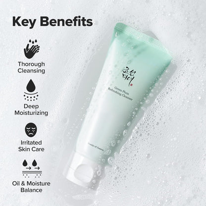 Green skincare cleanser tube with key benefits listed on a textured background