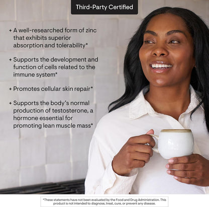 Woman holding a mug with text about zinc benefits on a white background