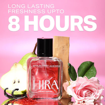 Perfume bottle labeled 'HIRA' with fruits and flowers on a pink background