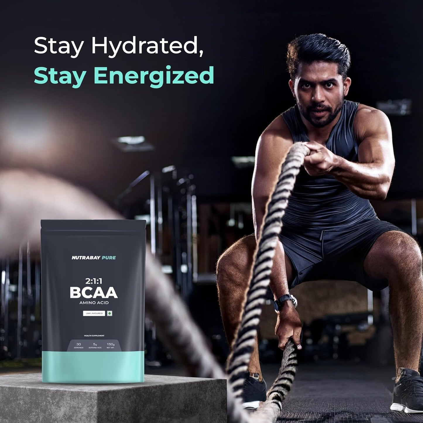 Man pulling ropes with a Nutrabeat BCAA supplement packaging in the foreground.