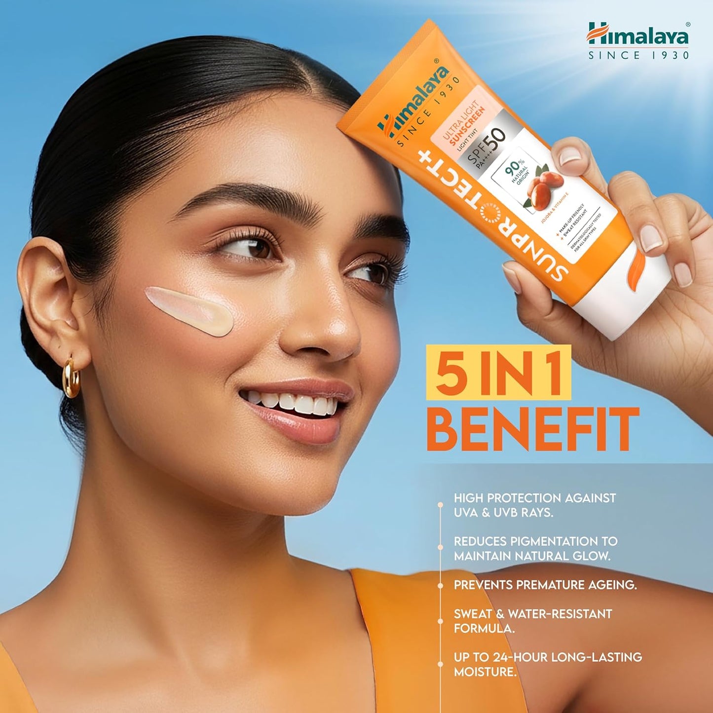 Woman with sunscreen on her face holding a Himalaya Sunscreen product against a blue background