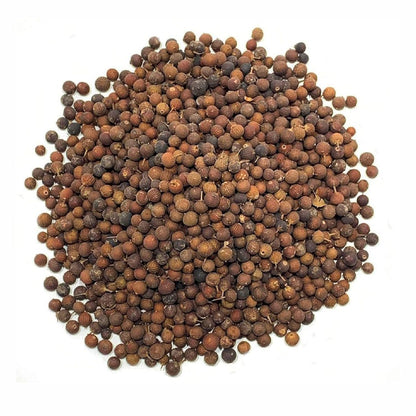 Pile of brown mustard seeds on a white background