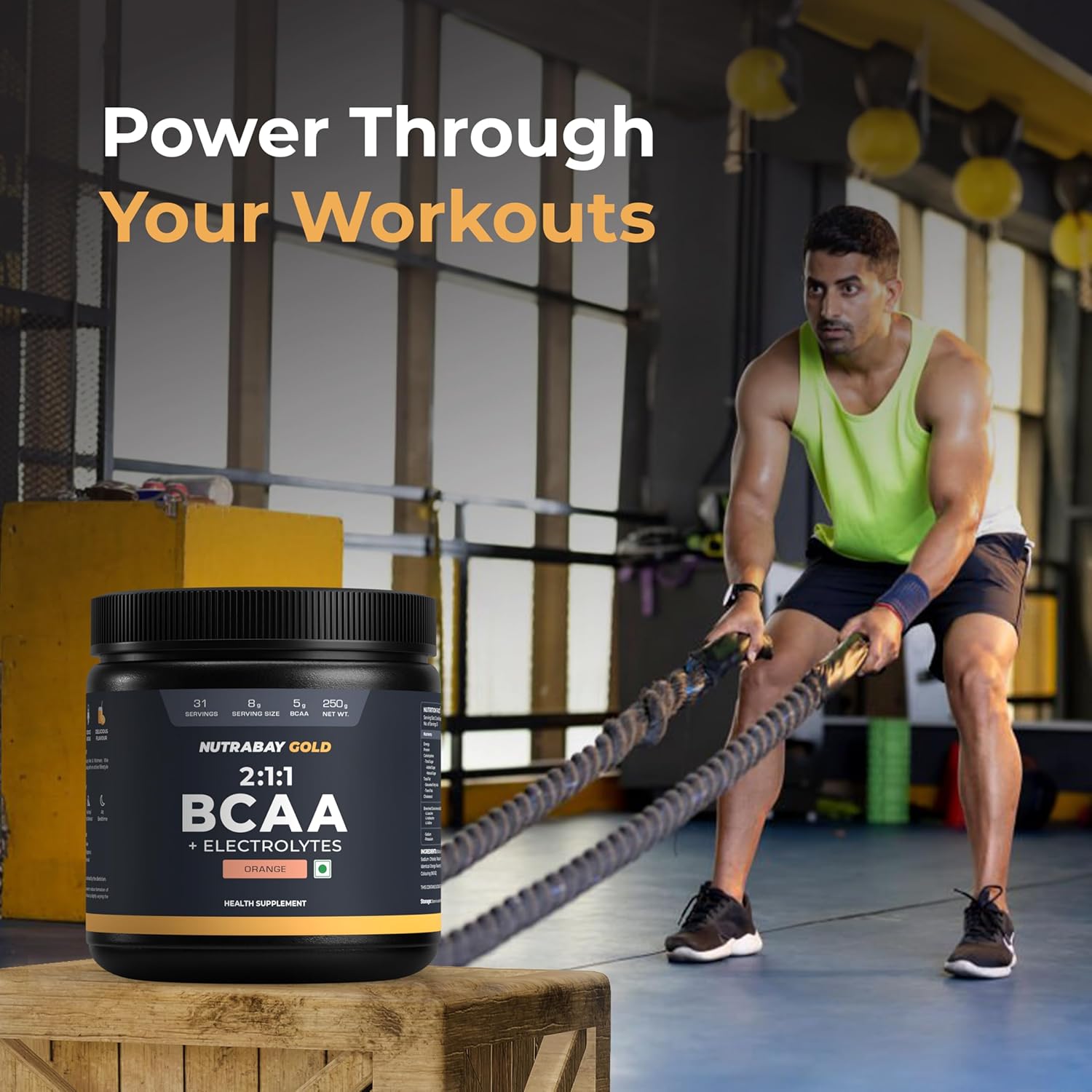Person using battle ropes with a supplement container labeled 'NutraKey Gold BCAA' in a gym setting.