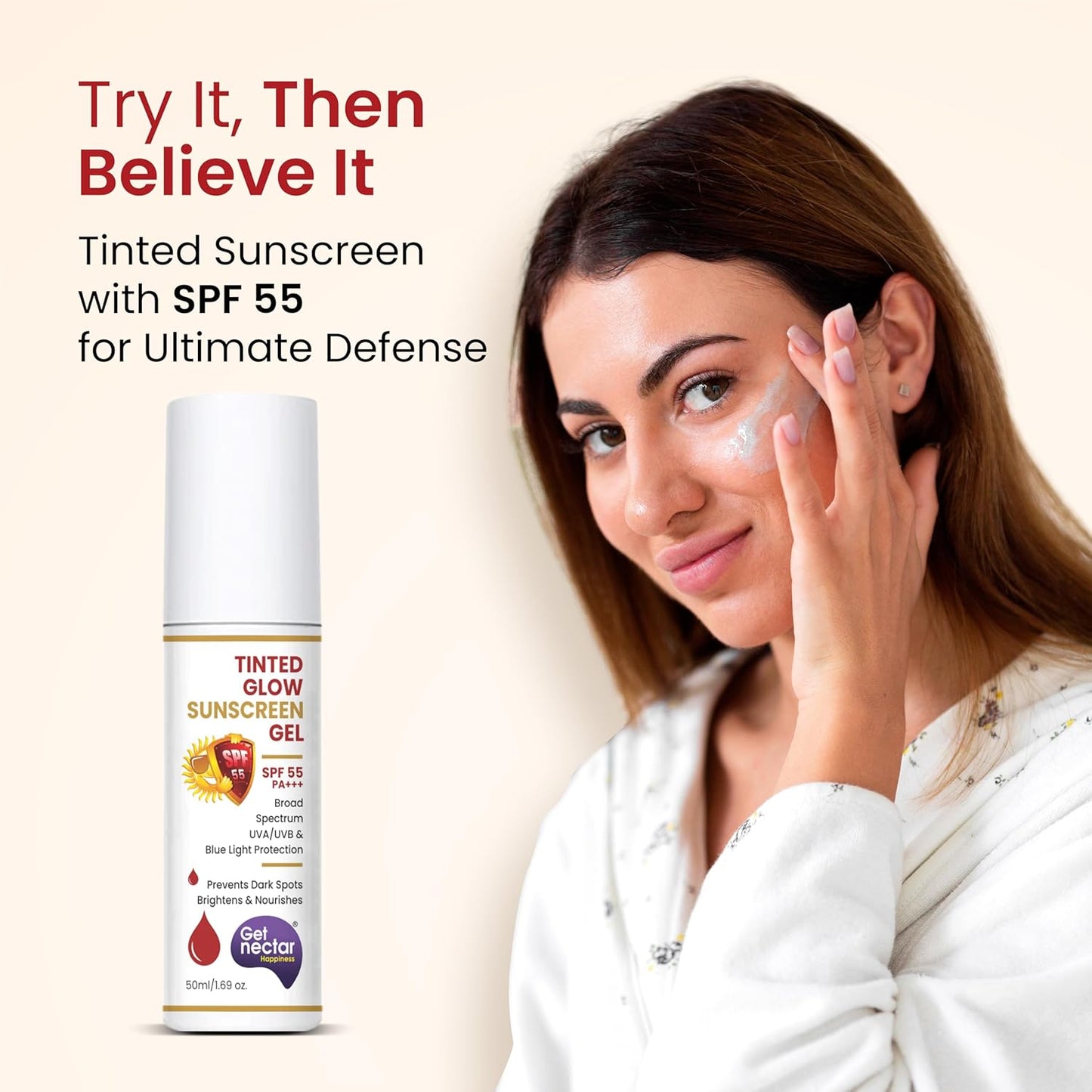 Woman applying sunscreen with a bottle of Nectar Tinted Glow Sunscreen Gel on a beige background