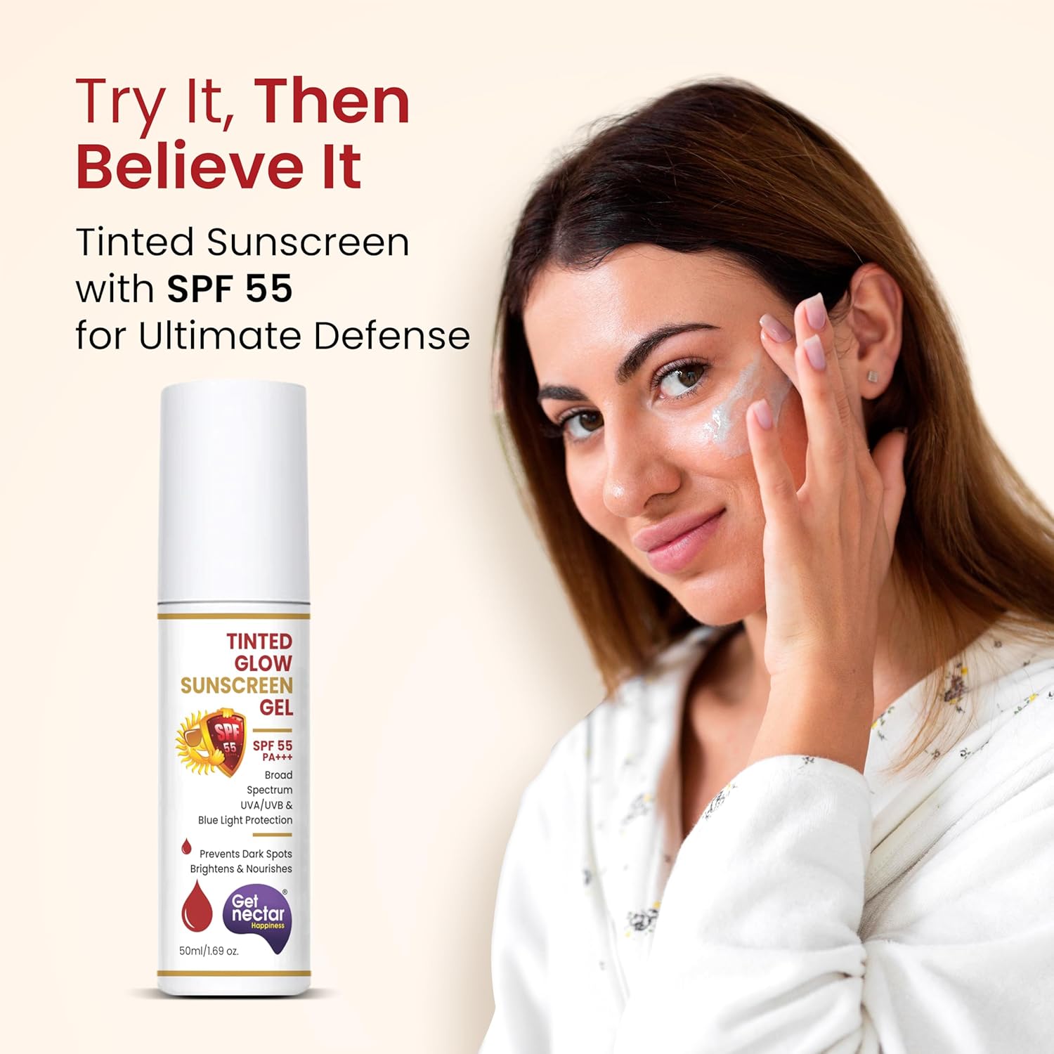 Woman applying sunscreen with a bottle of Nectar Tinted Glow Sunscreen Gel on a beige background