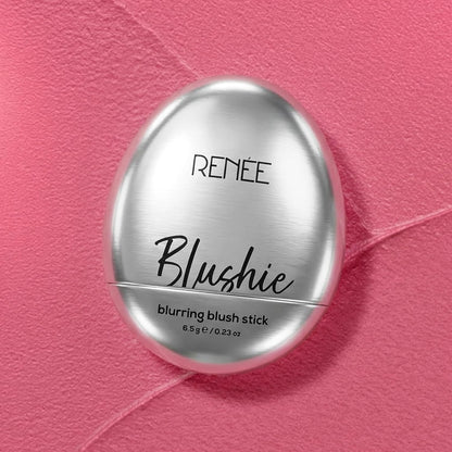 Silver blush stick with 'Renee' branding on a pink textured background