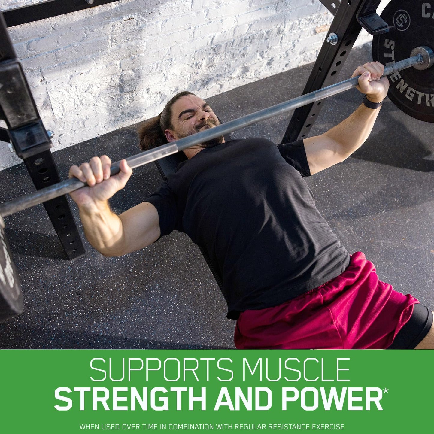 Person performing a bench press with a barbell on a gym floor, text about muscle strength and power.