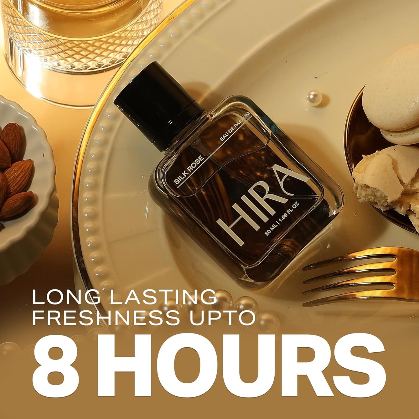 Perfume bottle labeled 'Hira' on a decorative plate with text about longevity, surrounded by almonds and cookies.