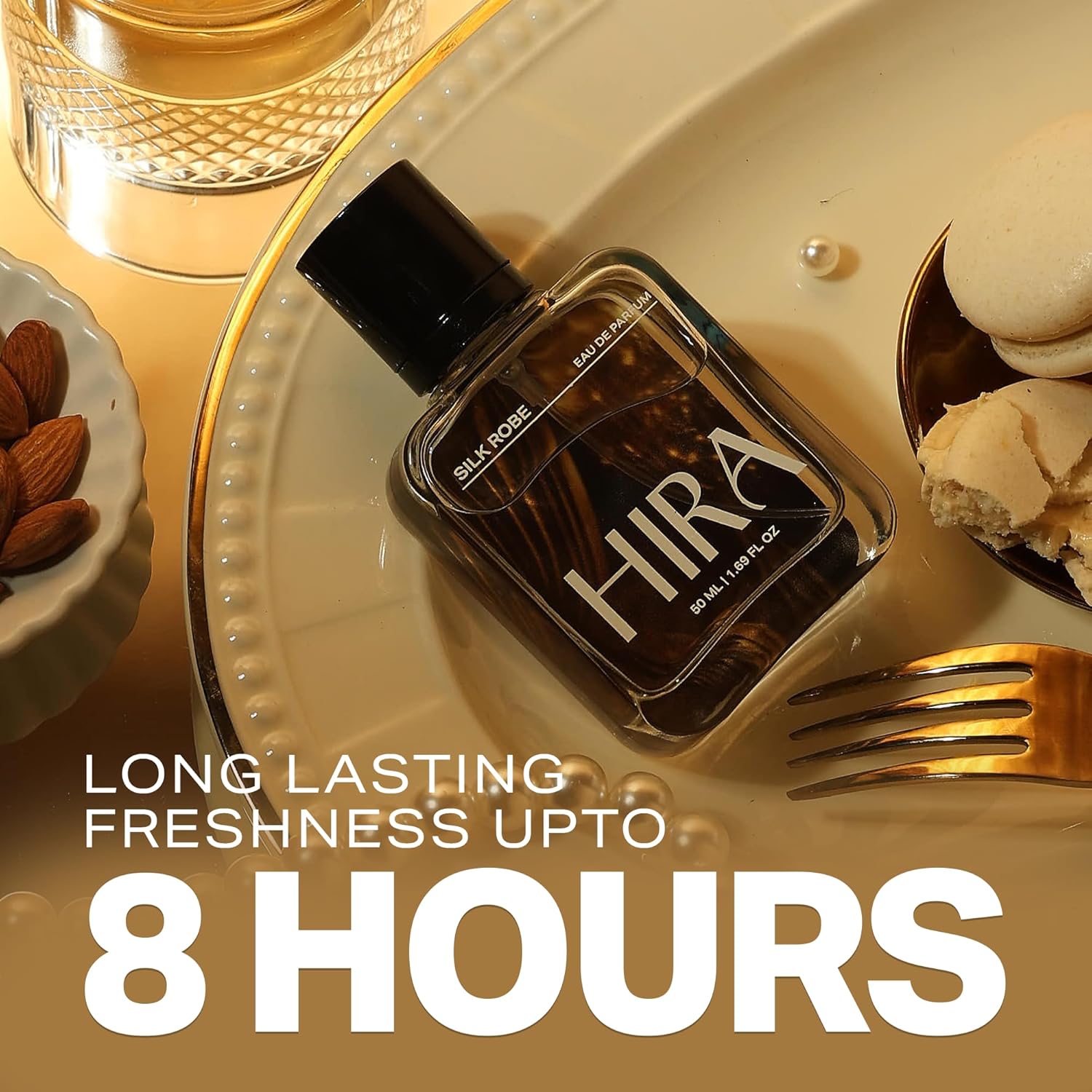 Perfume bottle labeled 'Hira' on a decorative plate with text about longevity, surrounded by almonds and cookies.