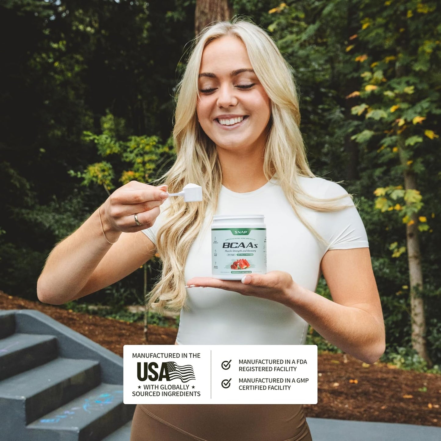 Woman holding a supplement container with a forest background
