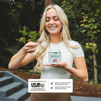 Woman holding a supplement container with a forest background