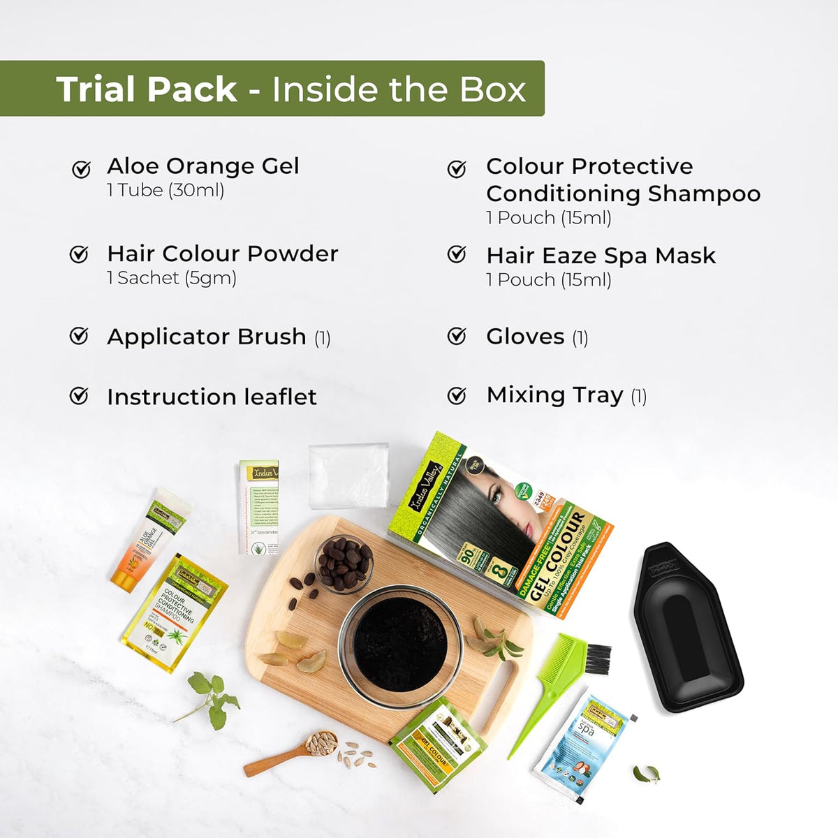 Trial pack contents with aloe orange gel, hair color powder, applicator brush, and other items on a white background.