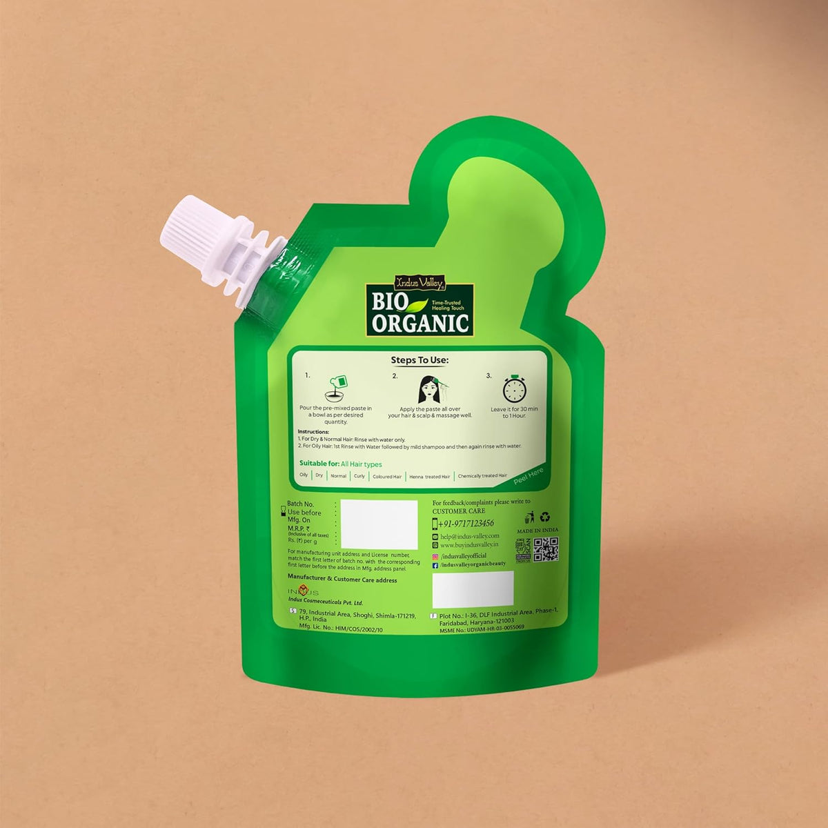 Green plastic packaging with a label on a beige background