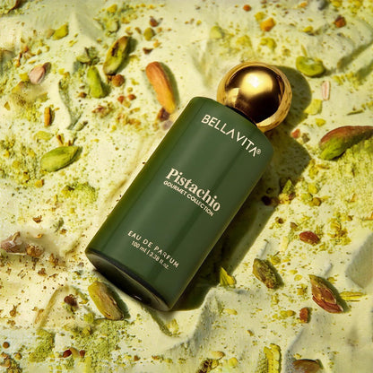 Green Bellavita Pistachio perfume bottle on a textured surface with pistachios.