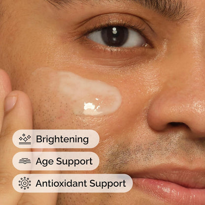 Close-up of a person's eye with a skincare product applied, labeled for brightening, age support, and antioxidant support.