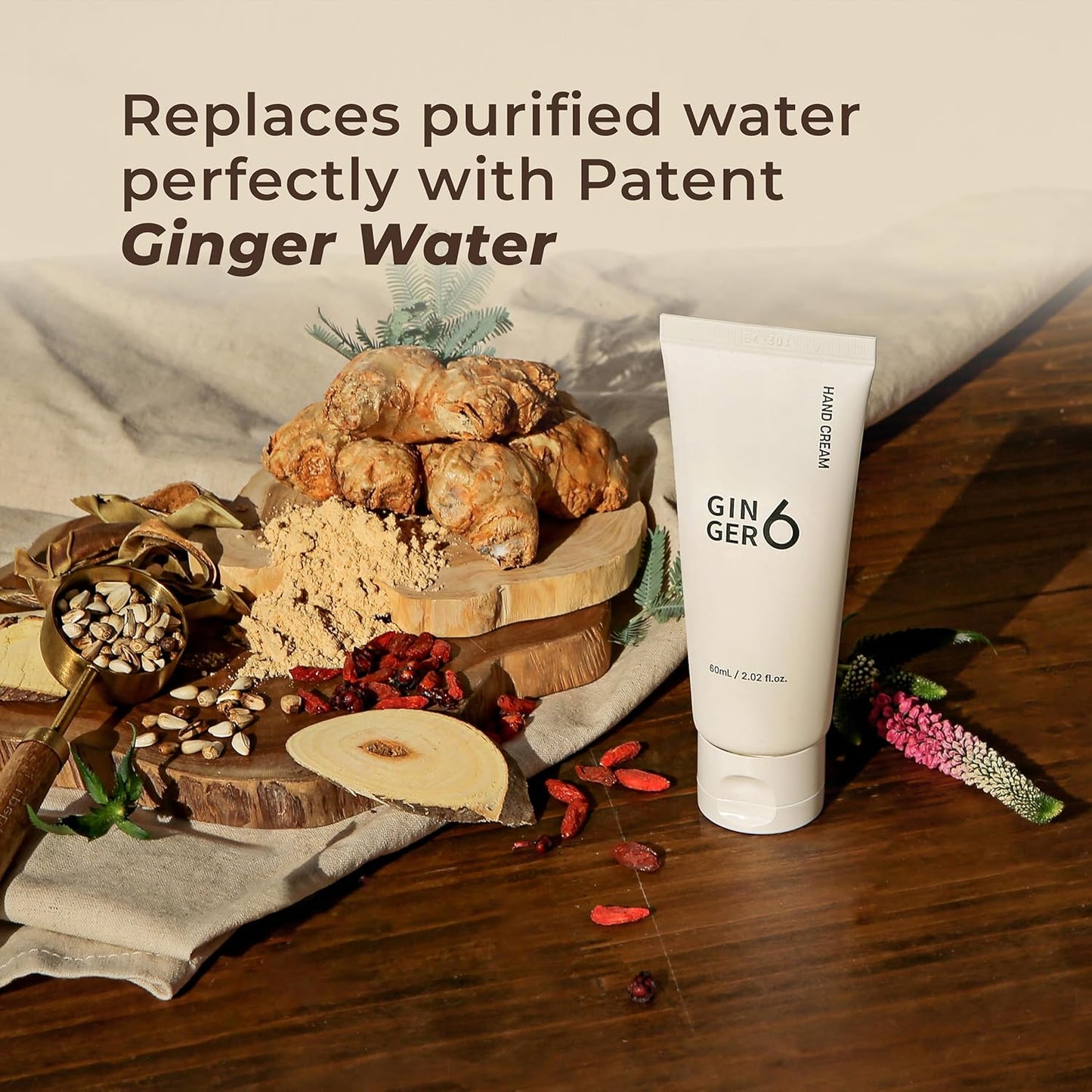 Gin & Ger hand cream on a wooden surface with natural elements and text about patent ginger water.