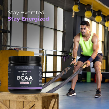 Person exercising with a supplement container labeled 'BCAA' in a gym setting.