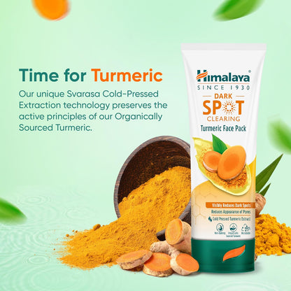 Himalaya Dark Spot Clearing Turmeric Face Pack with turmeric powder and turmeric roots on a light green background