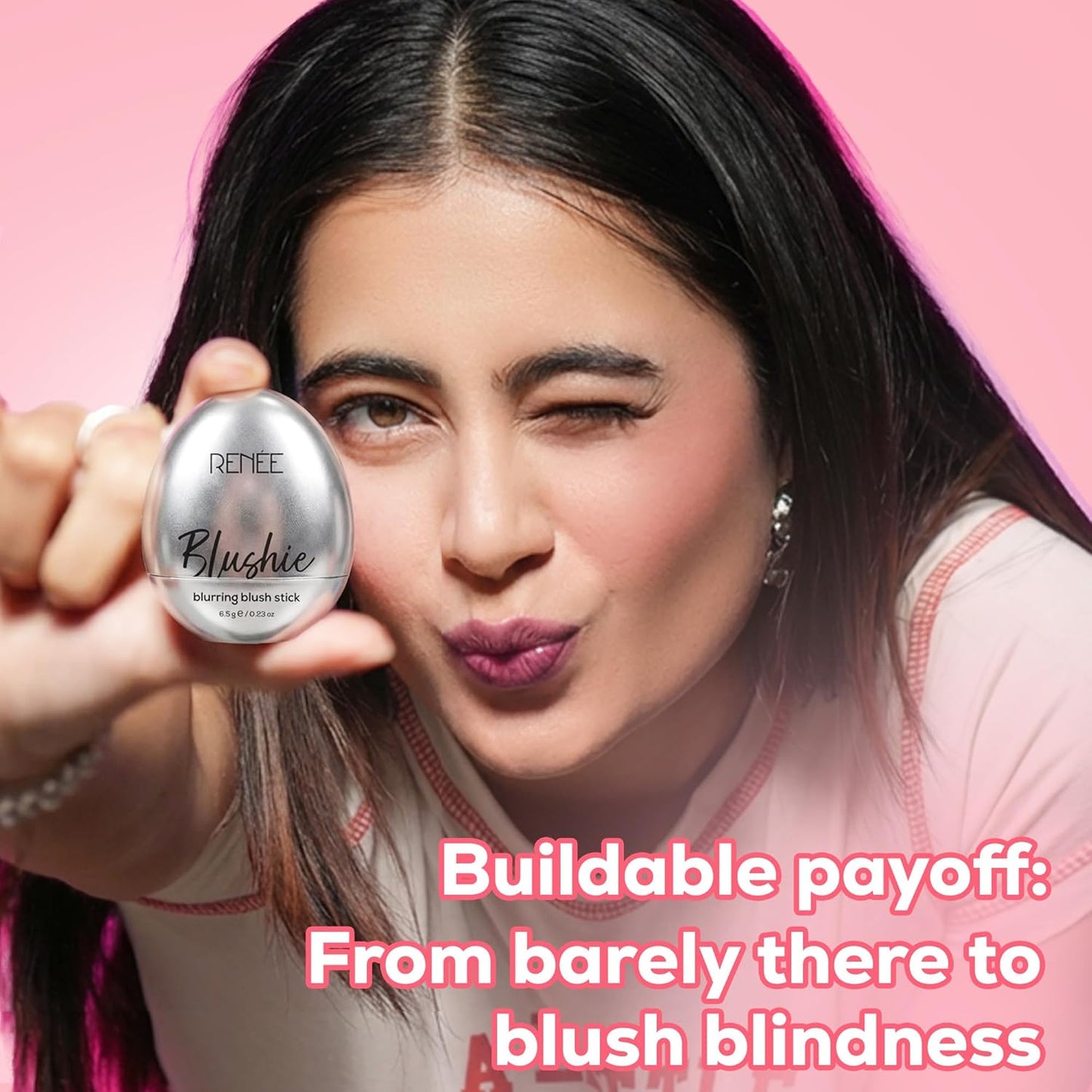 Woman holding a blush stick with text on a pink background