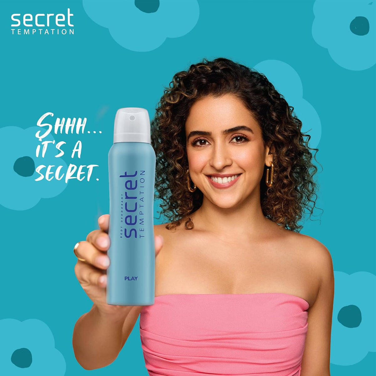 Woman holding a 'Secret Temptation' product with a blue floral background